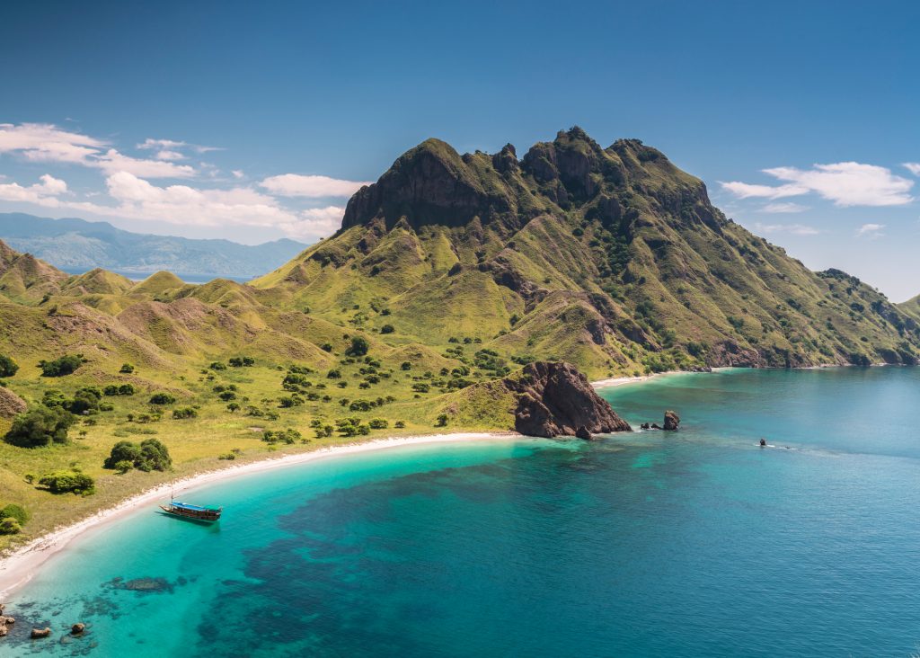 Aerial view of a beautiful bay with a white sand beach in the famous Komodo National Park in Flores island of Indonesia. Komodo is world wide famous for the diving sites and the Komodo dragon and holds also beautiful white sand beaches like this one.